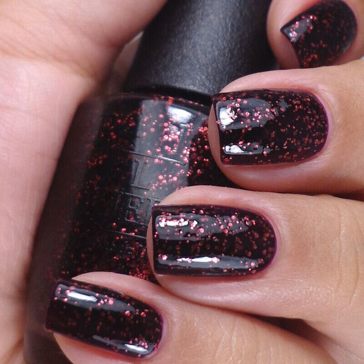 OPI Today I Accomplished Zero Red Pink Glitter in a jelly semi-sheer black base. This OPI Nail Polish is from the Coca-Cola Collection from 2014