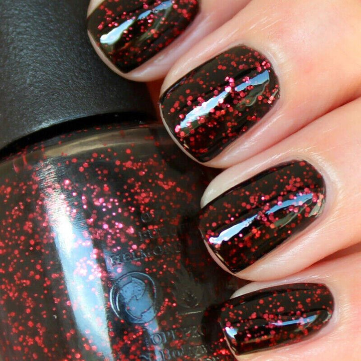 OPI Today I Accomplished Zero Red Pink Glitter in a jelly semi-sheer black base. This OPI Nail Polish is from the Coca-Cola Collection, product code is NLC17
